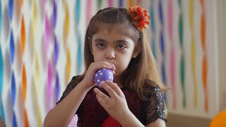 Cute little girl blowing purple balloon with white dots - Birt... | Indian Stock Footage | Knot9