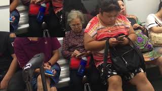 Elderly Lady in China using SmartPhone, Squashed beside Bigger Woman