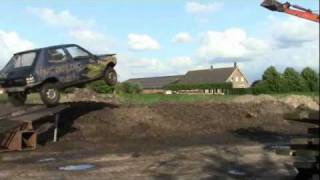 Peugeot 205 jumps into puddle of mud