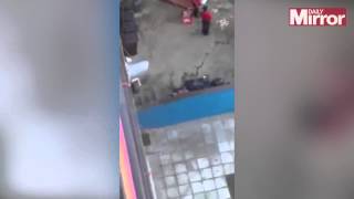 Watch KFC workers wash chicken on concrete floor behind fast food restaurant