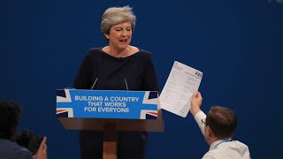 Prankster interrupts Theresa May's conference speech to hand her fake P45