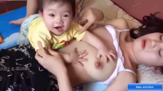 Breastfeeding   Putting on Pajmma and Baby   baby breastfeeding milk mama