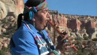Fernando Cecillion playing his flute in front of beautiful Zuni sacred mountain, Dowa Yallane