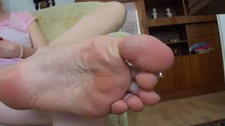 Woman spreads her toes and shows her big foot (size 11)