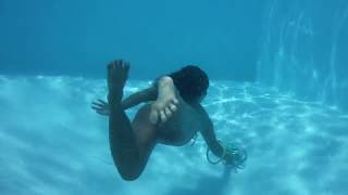 Freezing cold swimming pool challenge - girl swimming underwater and enjoying the pool