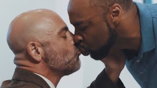 Real estate agent kissing black gay client to sell a house