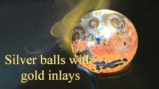 Silver balls with gold inlays
