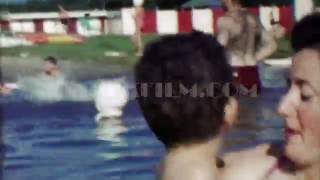 1963: Mom son playing in lake vacation waters on warm summer day. TAMPA, FLORIDA