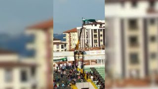 Banned Turkish football fan hires crane to watch his team play