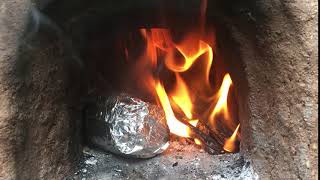 Fire-roasted corn on the cob in a clay/earth/cob oven