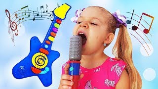 Diana finge brincar com instrumentos musicais de brinquedo