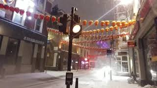 London: walking at night in Soho in London during the first snow, february 2018