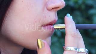 Woman Smokes in the Yard