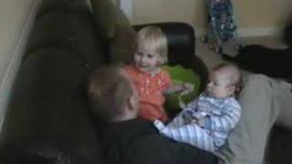 Two kids cuddle with Daddy