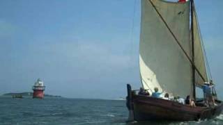 Shallop Elizabeth Tilley passing Bug Light in Plymouth Harbor