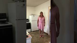 Crossdresser Paulette wearing pretty pink dress and sandals