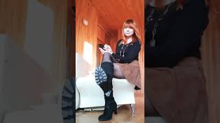 Foot fetish video. Redhead foot goddess in black nylon and boots ignoring you with her smartphone