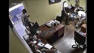 Surveillance video of auto parts store owner fighting back against two gunmen