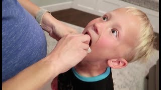 Mom pulls son's first tooth!