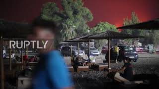Greece: Locals sleep on beach as wildfires turn sky orange on Evia island