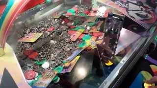 crazy gambling addict plays Wizard of Oz coin pusher game at nickel arcade