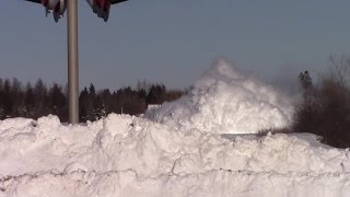 Train plows through snow bank