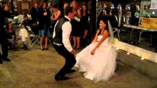 Groom gets iced during garter toss at wedding