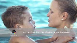 Boy kissing mother while bathing in the sea