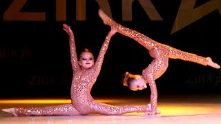 Two small artists perform in a duet on the stage of the Talent Show Zirka