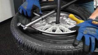 Change a car tire on a No-Mar scratch proof tire changer