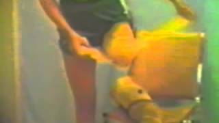 female left above the knee amputee is bandaging her stump standing