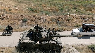 Syrian soldiers celebrate recapturing the country's main border crossing with Jordan