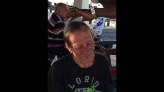 Giving free haircut for homeless at Waikiki Beach