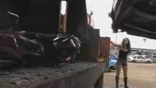 girl crushing a car with compactor