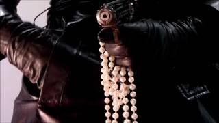 Woman Wearing Leather Trench Coat, Leather Gloves, Playing with Gun and Pearls
