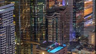 Skyline of the buildings of Sheikh Zayed Road and DIFC aerial night timelapse in Dubai, UAE.
