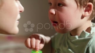 Mom and her son kissing. Lovely close ups.. Stock Footage